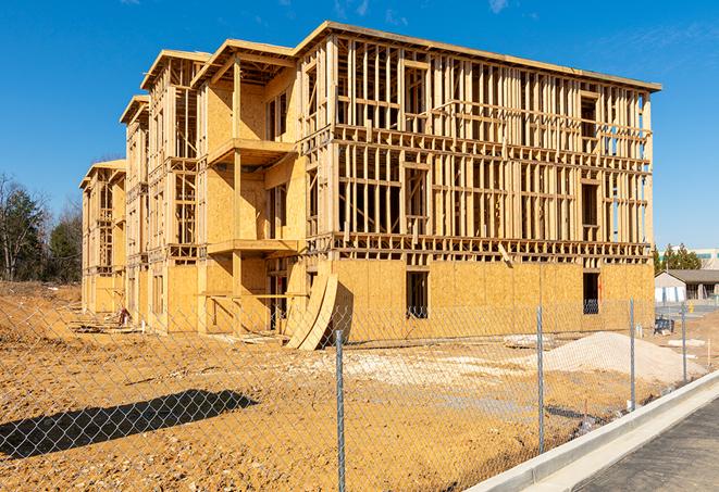 a temporary chain link fence winding around a job site, outlining the project's progress in Commerce CA